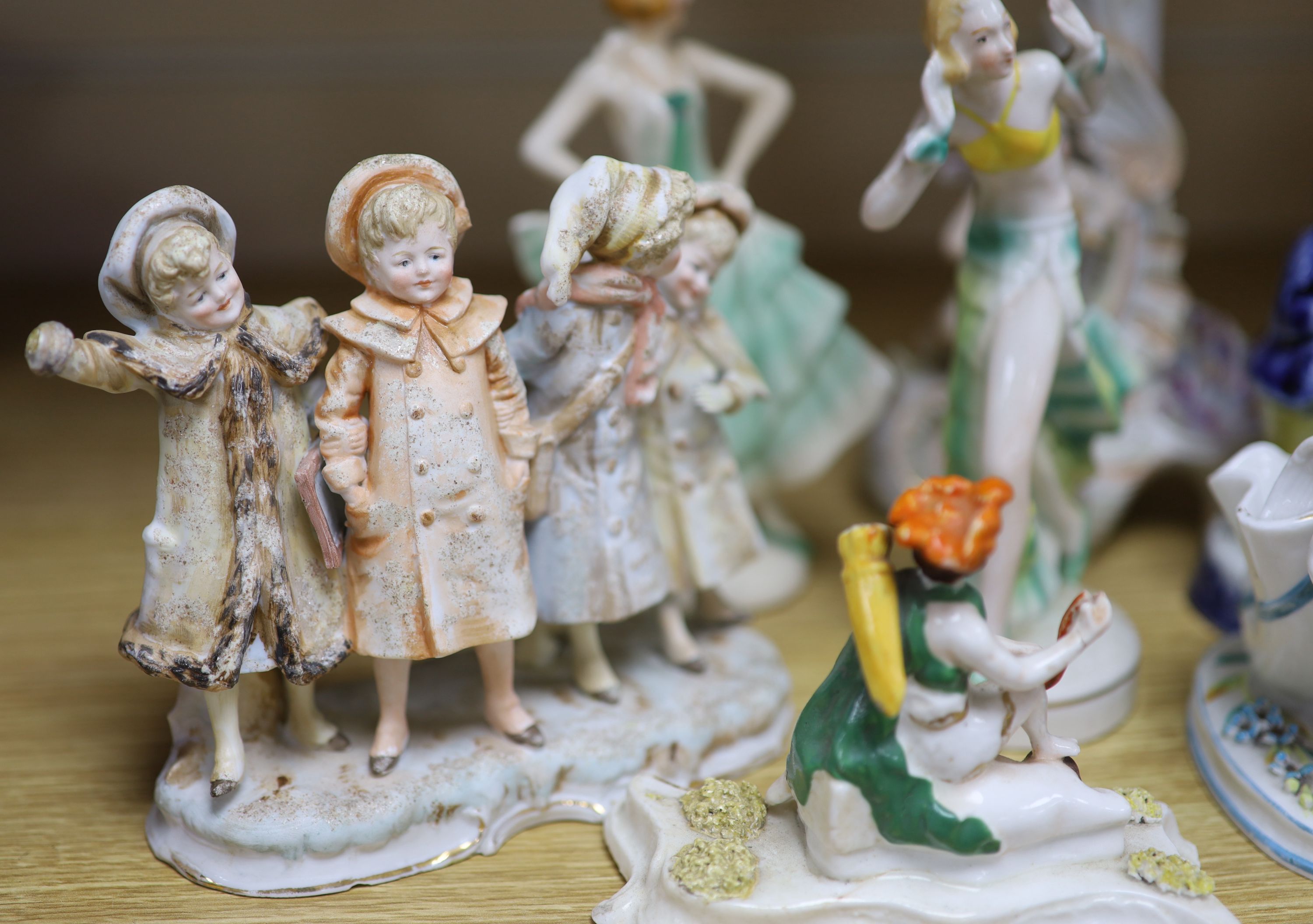 A collection of Art Deco ceramic dancing ladies, a 19th century figural box, a candlestick and a Toby jug, etc., tallest 22cm